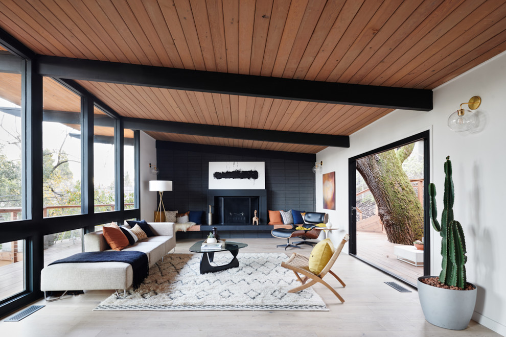 Mid-century modern living room photo in San Francisco with white walls and a standard fireplace