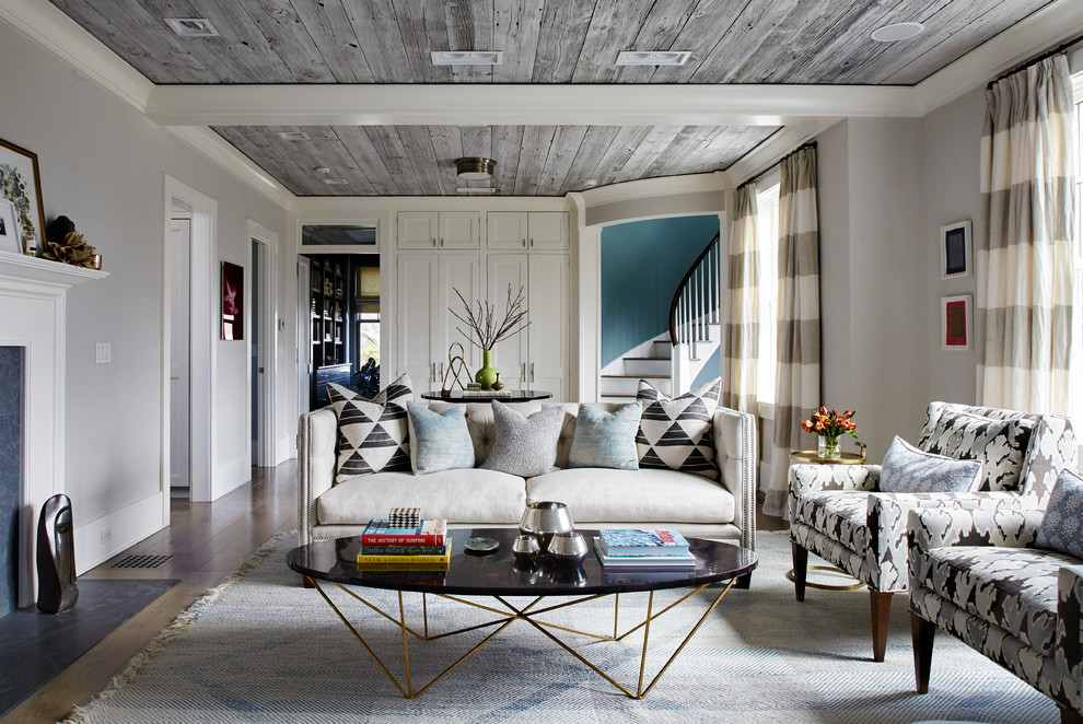 Photo of a classic formal open plan living room in New York with grey walls, a stone fireplace surround and no tv.