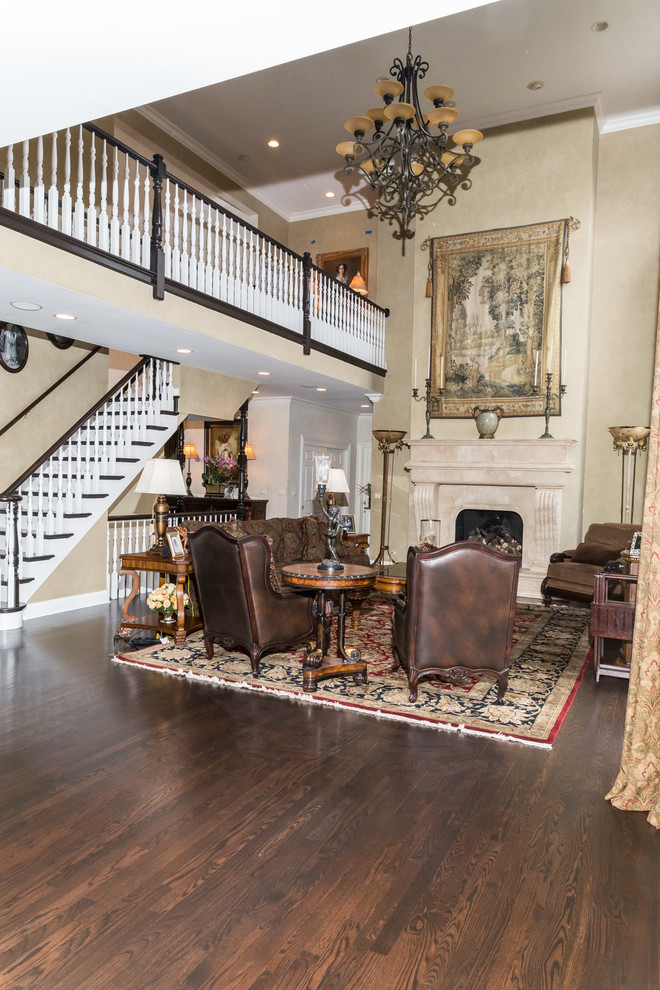 Example of a large arts and crafts formal and open concept dark wood floor and brown floor living room design in Chicago with beige walls, a standard fireplace, a stone fireplace and no tv