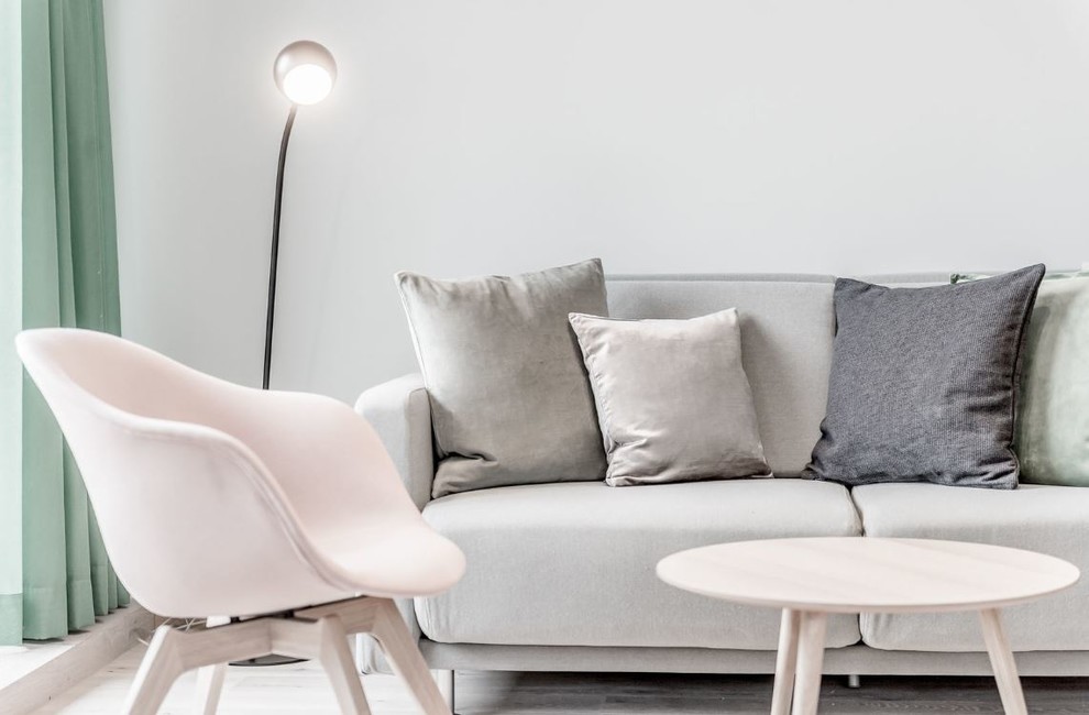 This is an example of a small scandi living room in Manchester with white walls and light hardwood flooring.