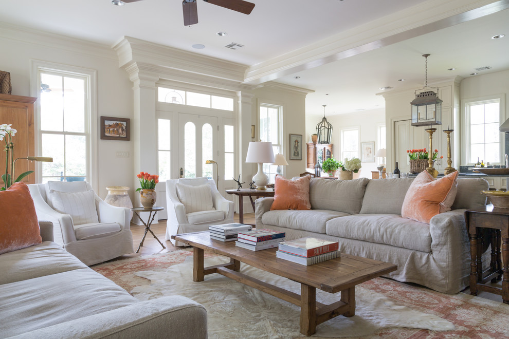 Living room - mid-sized country open concept light wood floor and beige floor living room idea in New Orleans with white walls, a standard fireplace, a brick fireplace and a wall-mounted tv