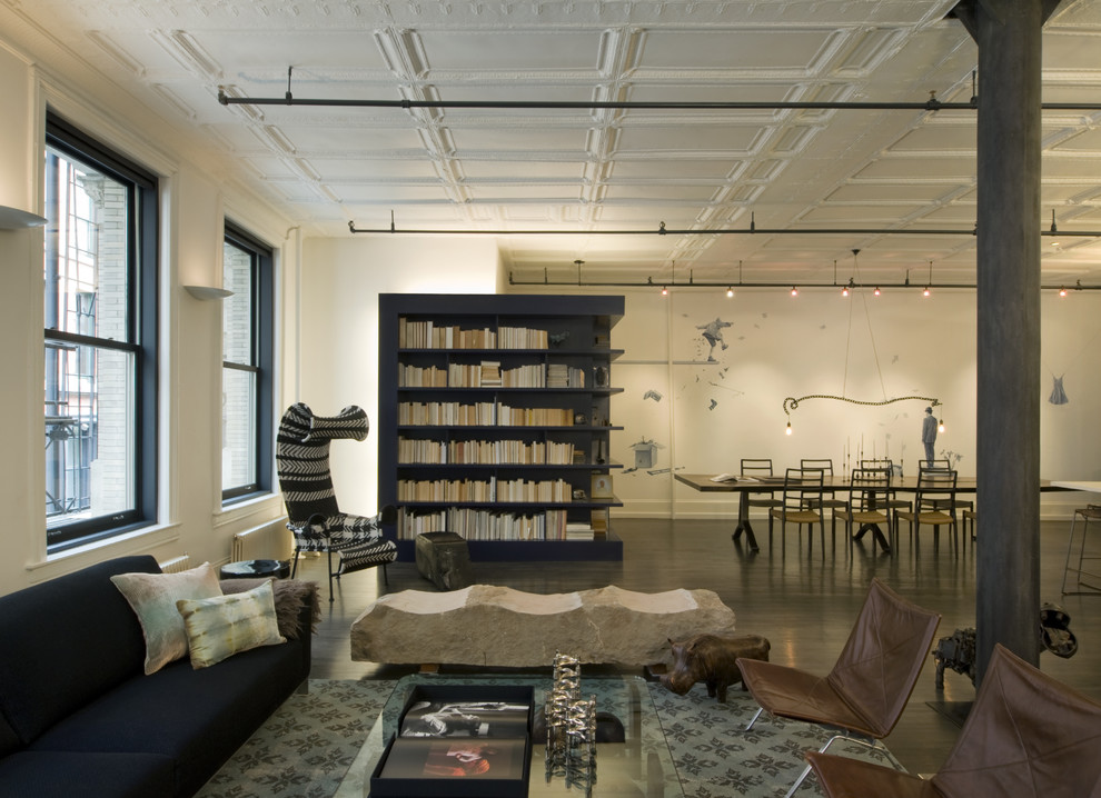 Photo of an industrial living room in New York with white walls.