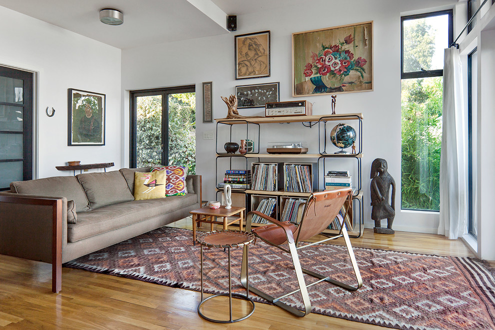 Mid-sized danish open concept medium tone wood floor living room photo in Los Angeles with a music area