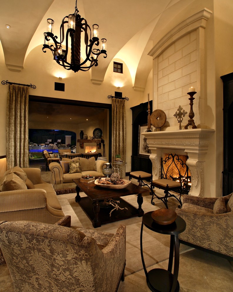 This is an example of a large mediterranean formal open plan living room in Phoenix with travertine flooring, a standard fireplace, white walls, a stone fireplace surround, no tv and beige floors.