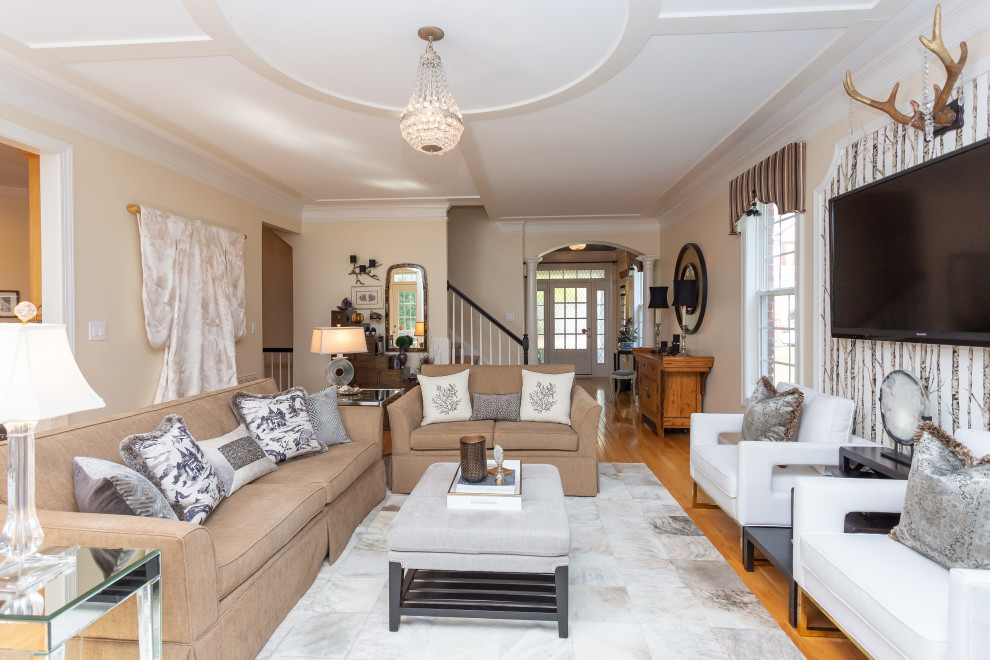 Design ideas for a medium sized eclectic open plan living room in Raleigh with beige walls, light hardwood flooring, a standard fireplace, a wooden fireplace surround, a wall mounted tv, a coffered ceiling and wallpapered walls.