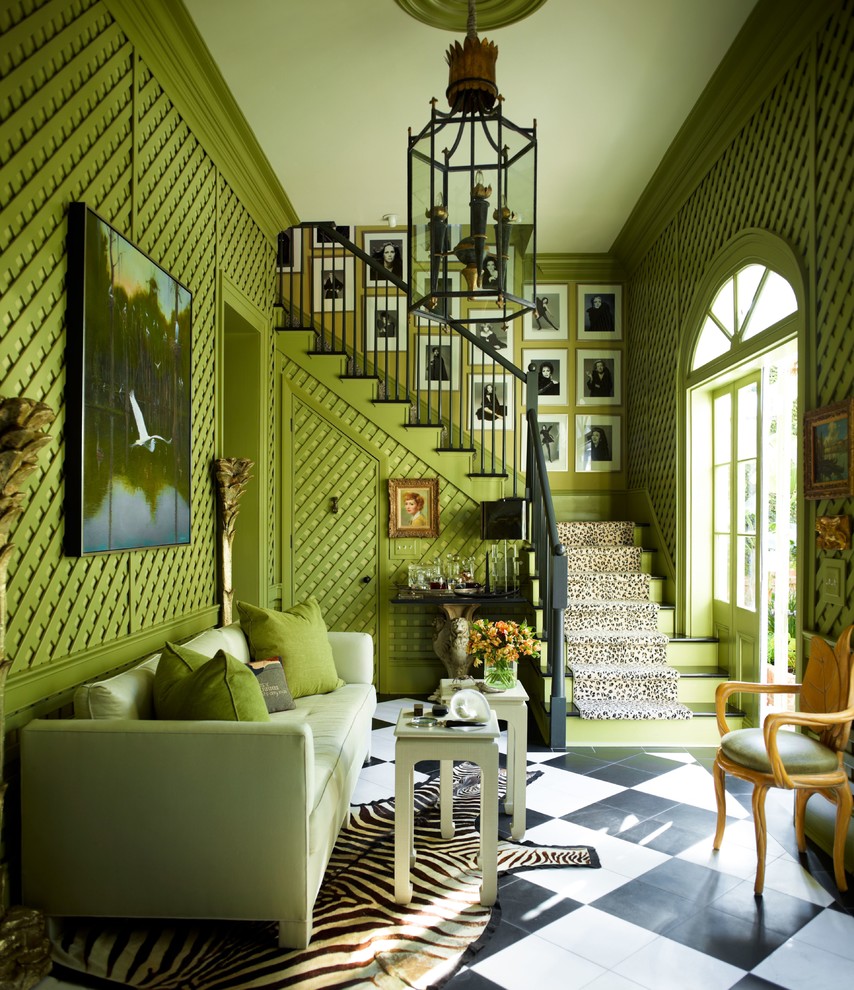 Example of a large classic formal living room design in New York with green walls, no tv and no fireplace