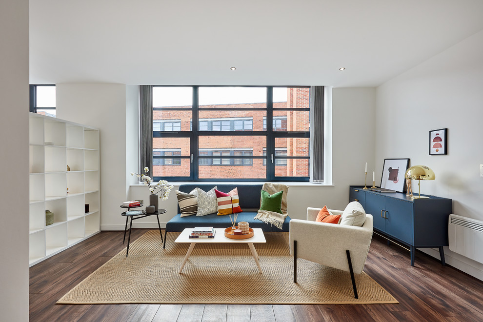 Photo of a contemporary open plan living room in Other with grey walls, dark hardwood flooring and brown floors.