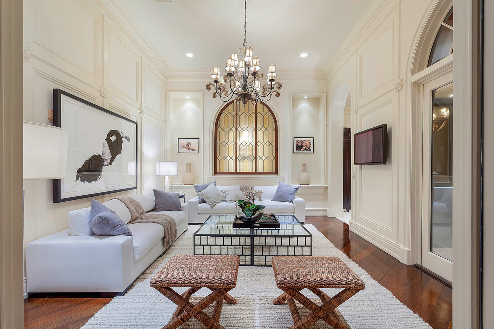 Traditional living room in Miami with beige walls, medium hardwood flooring, a wall mounted tv and red floors.