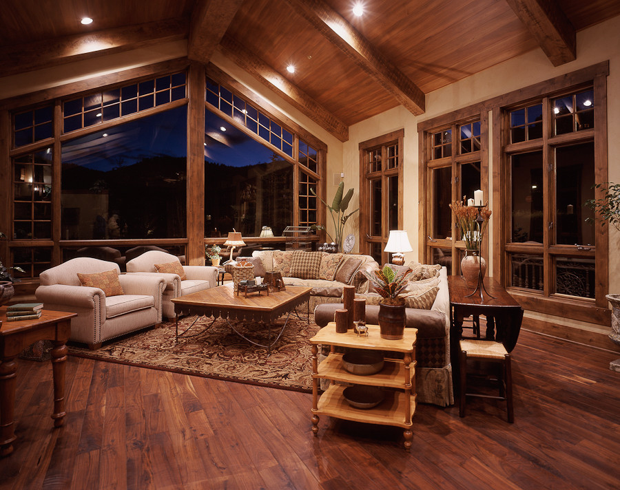 Inspiration for a huge rustic open concept dark wood floor living room remodel in Salt Lake City with beige walls, a two-sided fireplace, a stone fireplace and no tv
