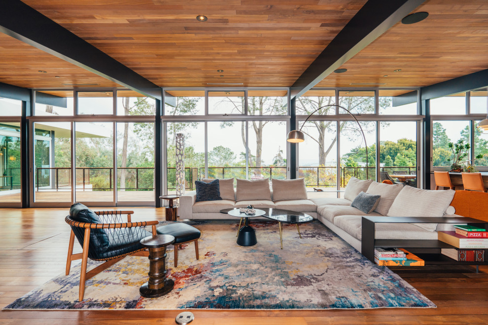 Living room - mid-century modern formal and open concept medium tone wood floor, exposed beam and wood ceiling living room idea