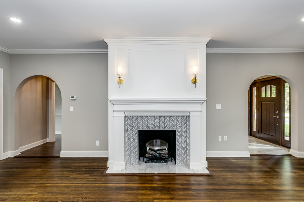 Inspiration for a mid-sized timeless dark wood floor and brown floor living room remodel in Wichita with gray walls, a standard fireplace and a tile fireplace