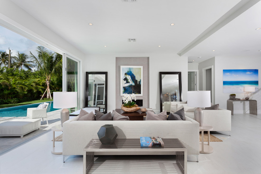 Living room - contemporary open concept living room idea in Miami with white walls and a ribbon fireplace