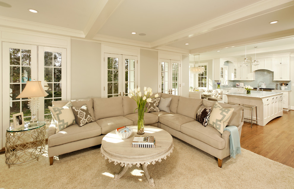 This is an example of a traditional open plan living room in DC Metro with beige walls.