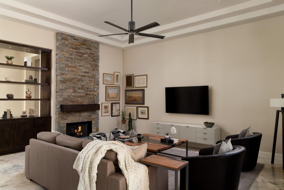 Inspiration for a contemporary gray floor living room remodel in Phoenix with beige walls, a standard fireplace, a stone fireplace and a wall-mounted tv