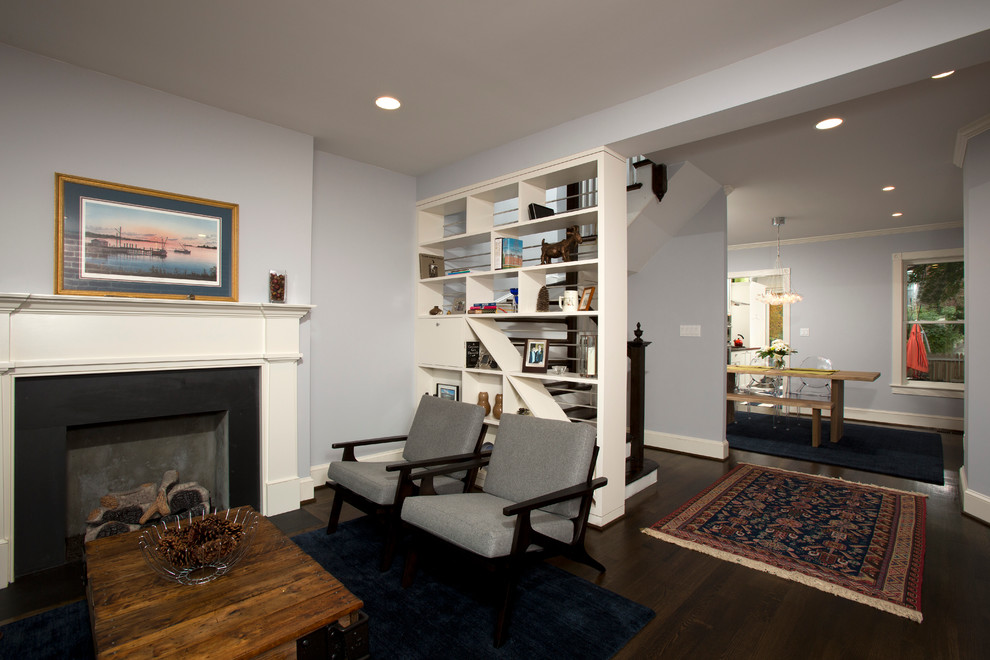 This is an example of a small traditional formal open plan living room in DC Metro with brown walls, dark hardwood flooring, a standard fireplace, no tv and a concrete fireplace surround.