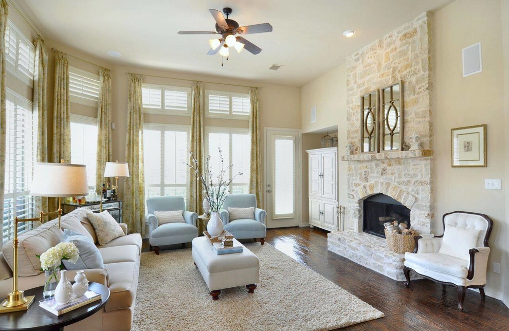 Photo of a large classic formal enclosed living room in Dallas with beige walls, dark hardwood flooring, a standard fireplace, a stone fireplace surround and no tv.