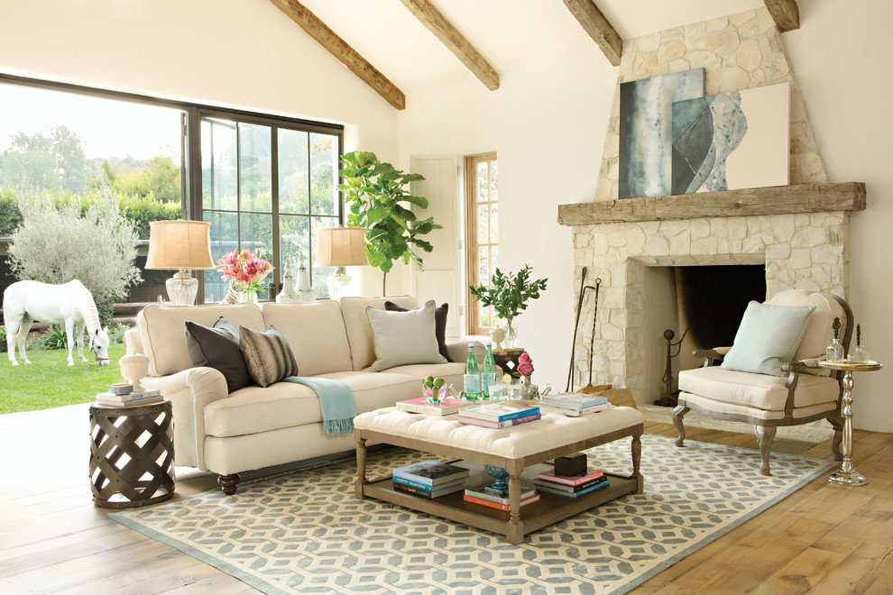 Inspiration for a mid-sized timeless formal and open concept medium tone wood floor living room remodel in Los Angeles with beige walls, no tv, a standard fireplace and a stone fireplace