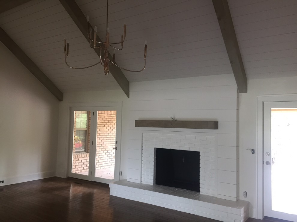 Inspiration for a mid-sized contemporary enclosed dark wood floor living room remodel in Oklahoma City with white walls, a standard fireplace and a brick fireplace