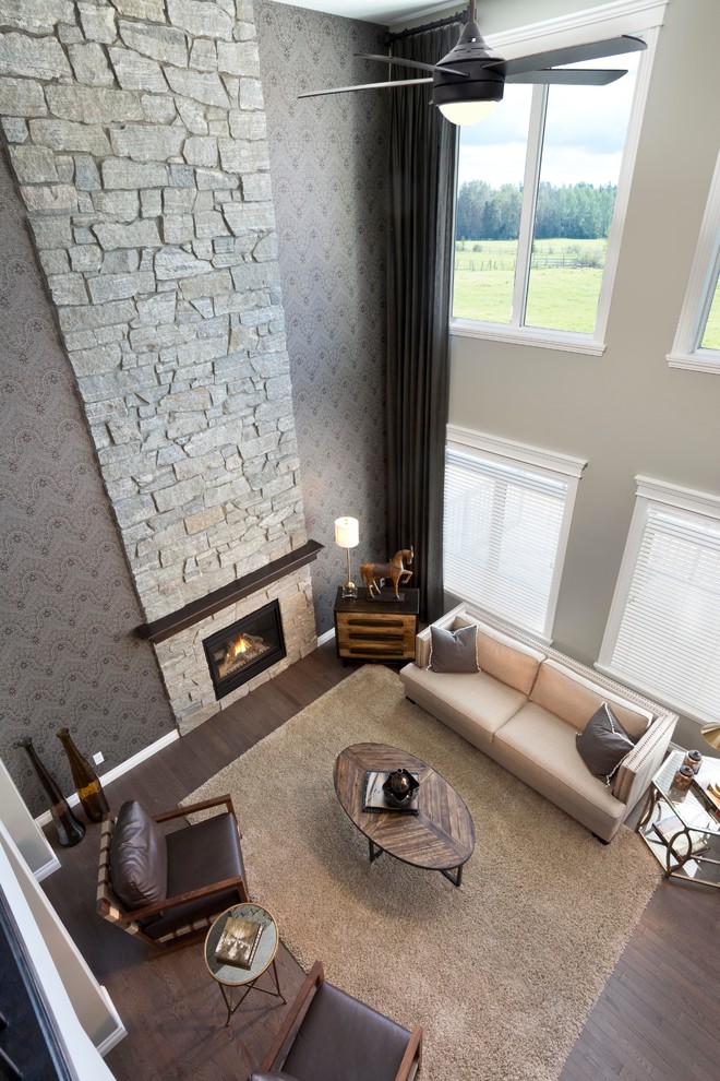 Design ideas for a contemporary formal mezzanine living room in Calgary with grey walls, medium hardwood flooring, a standard fireplace and a stone fireplace surround.
