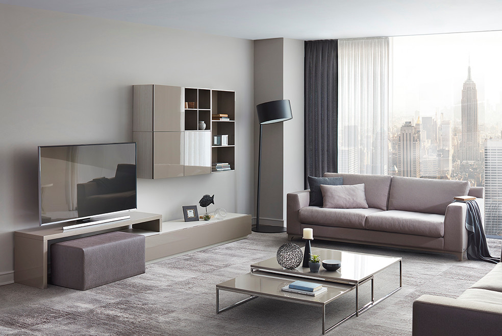 Photo of a medium sized modern open plan living room in New York with beige walls, carpet and a wall mounted tv.