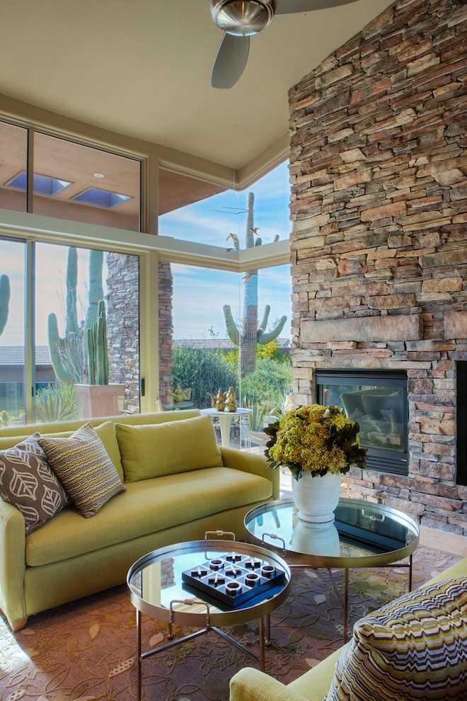 Living room - southwestern living room idea in Phoenix with beige walls, a standard fireplace and a stone fireplace