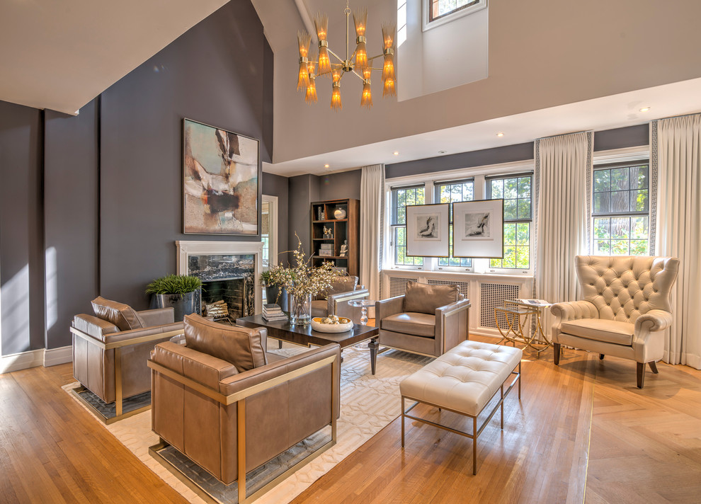 Example of a huge transitional loft-style light wood floor living room design in Detroit with gray walls, a standard fireplace, a stone fireplace and no tv