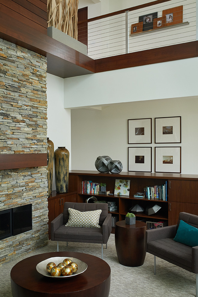 This is an example of a large contemporary open plan living room in Grand Rapids with white walls, carpet, a ribbon fireplace, a stone fireplace surround, a wall mounted tv and beige floors.