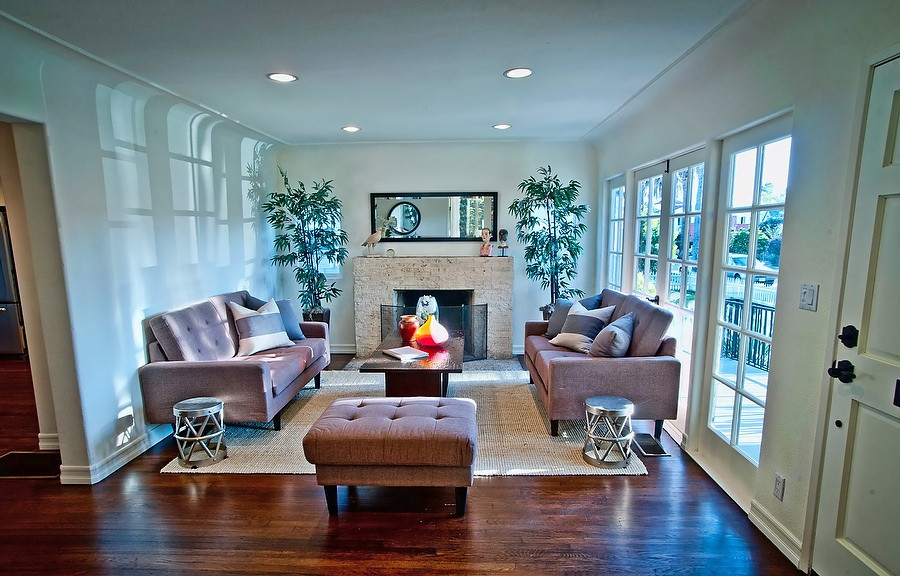 Inspiration for a traditional formal enclosed living room in Los Angeles with white walls, dark hardwood flooring, a standard fireplace, a brick fireplace surround and brown floors.