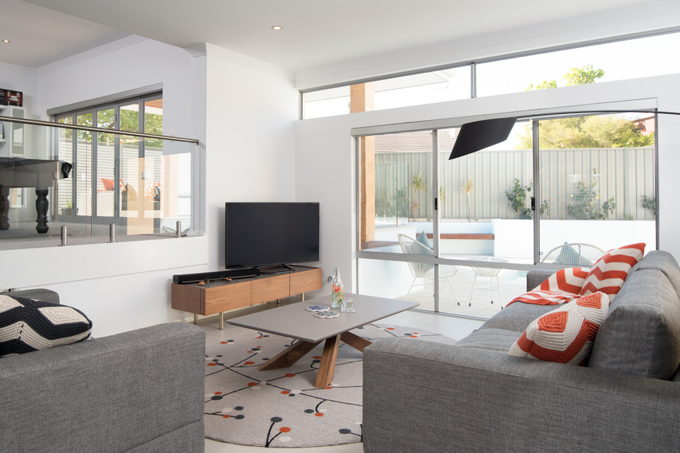 This is an example of a medium sized contemporary formal open plan living room in Perth with white walls, porcelain flooring and a freestanding tv.