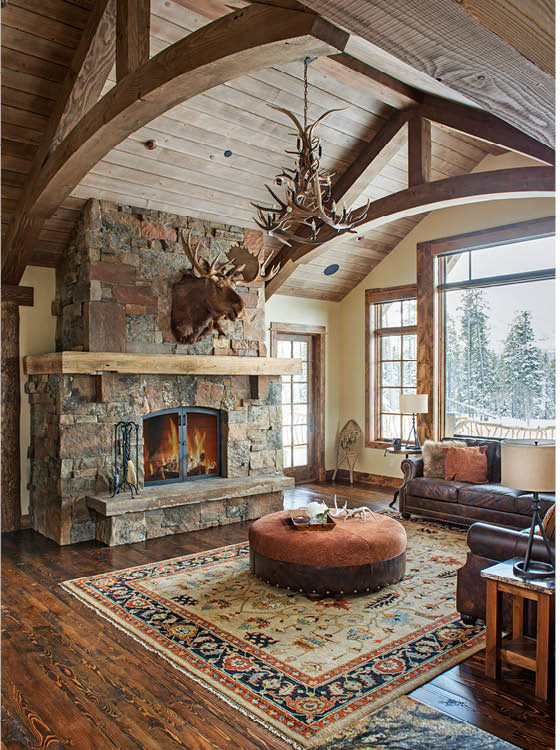Photo of a medium sized rustic formal open plan living room in Other with beige walls, medium hardwood flooring, a standard fireplace, a stone fireplace surround and brown floors.