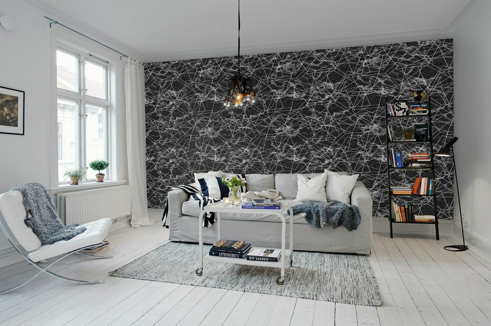 Inspiration for a mid-sized scandinavian enclosed painted wood floor living room remodel in Gothenburg with black walls, no fireplace and no tv