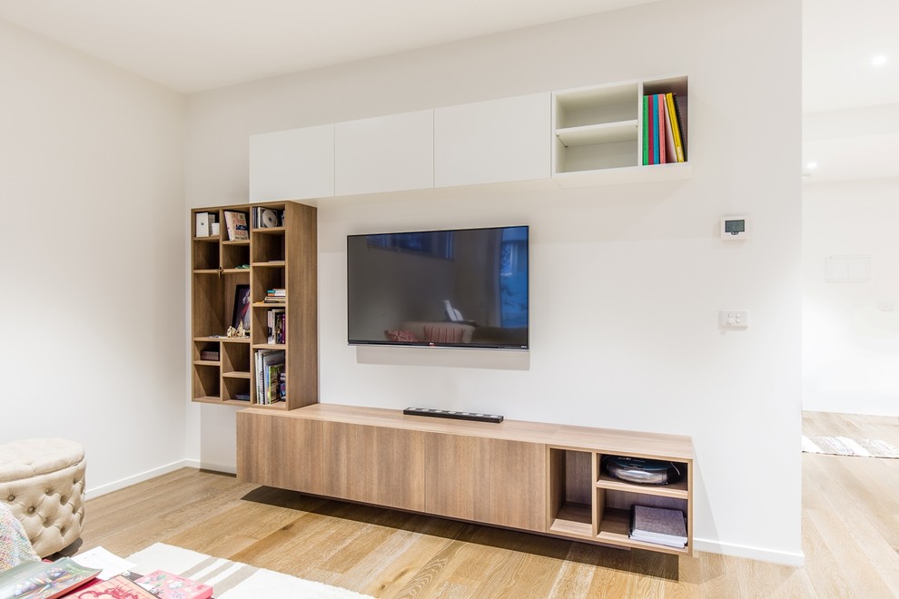 Inspiration for a medium sized contemporary living room in Melbourne with a wall mounted tv, white walls, medium hardwood flooring and no fireplace.