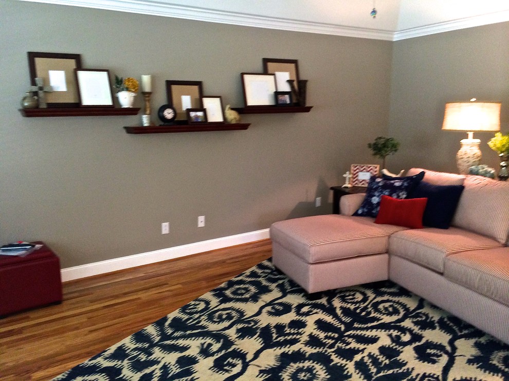 Example of a mid-sized country enclosed medium tone wood floor living room design in Nashville with brown walls