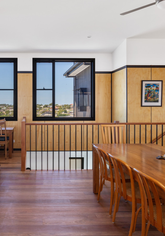 Foto di un soggiorno design di medie dimensioni e aperto con parquet scuro, pavimento marrone, soffitto a volta, pareti in legno e pareti marroni