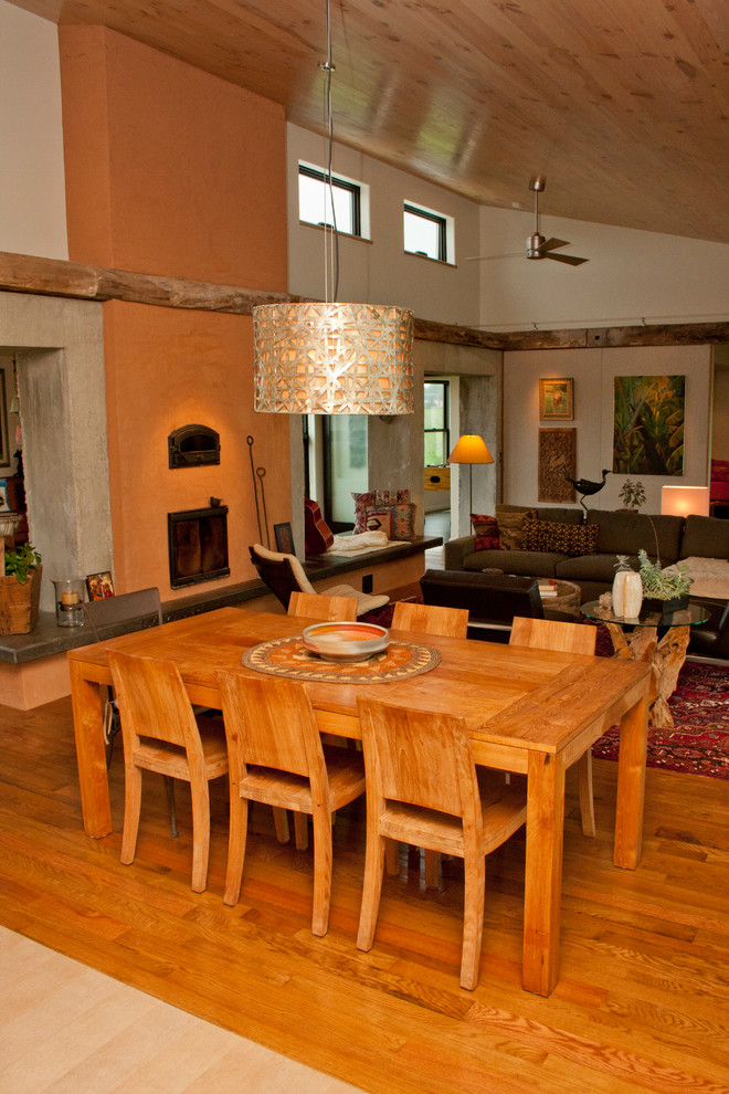 Exemple d'un salon moderne de taille moyenne et ouvert avec un sol en bois brun, un manteau de cheminée en plâtre, un sol marron, un mur blanc, une salle de réception, un poêle à bois et aucun téléviseur.