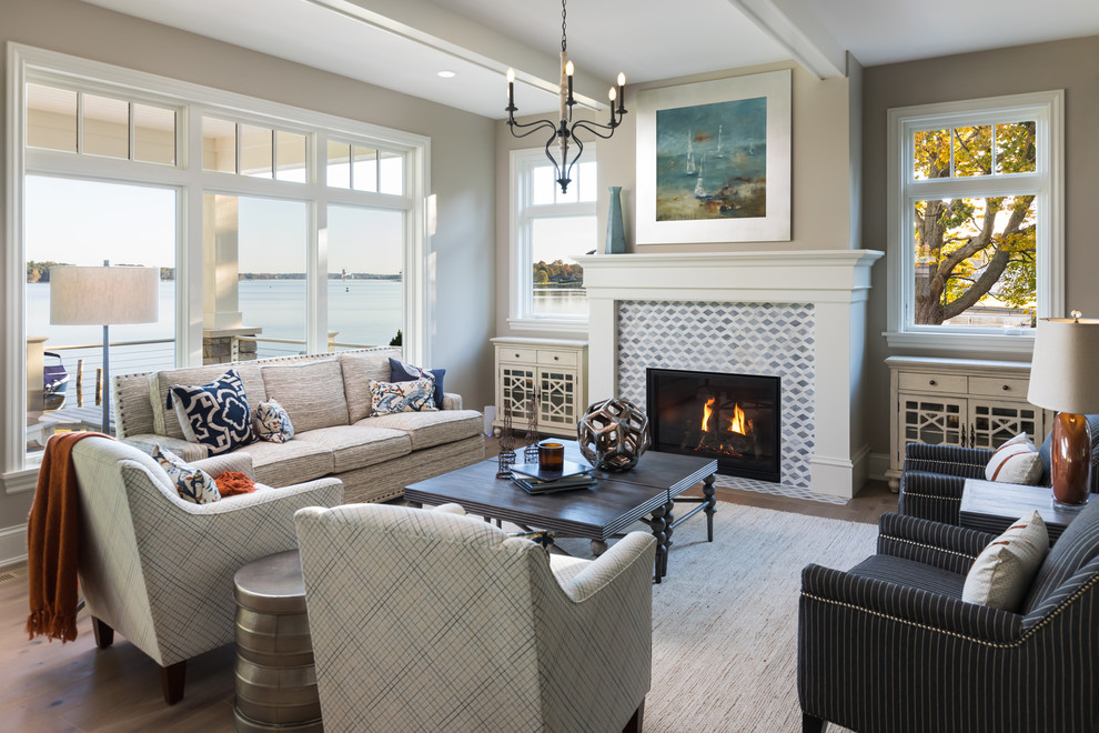 This is an example of a nautical formal living room in Grand Rapids with grey walls, a standard fireplace and a tiled fireplace surround.