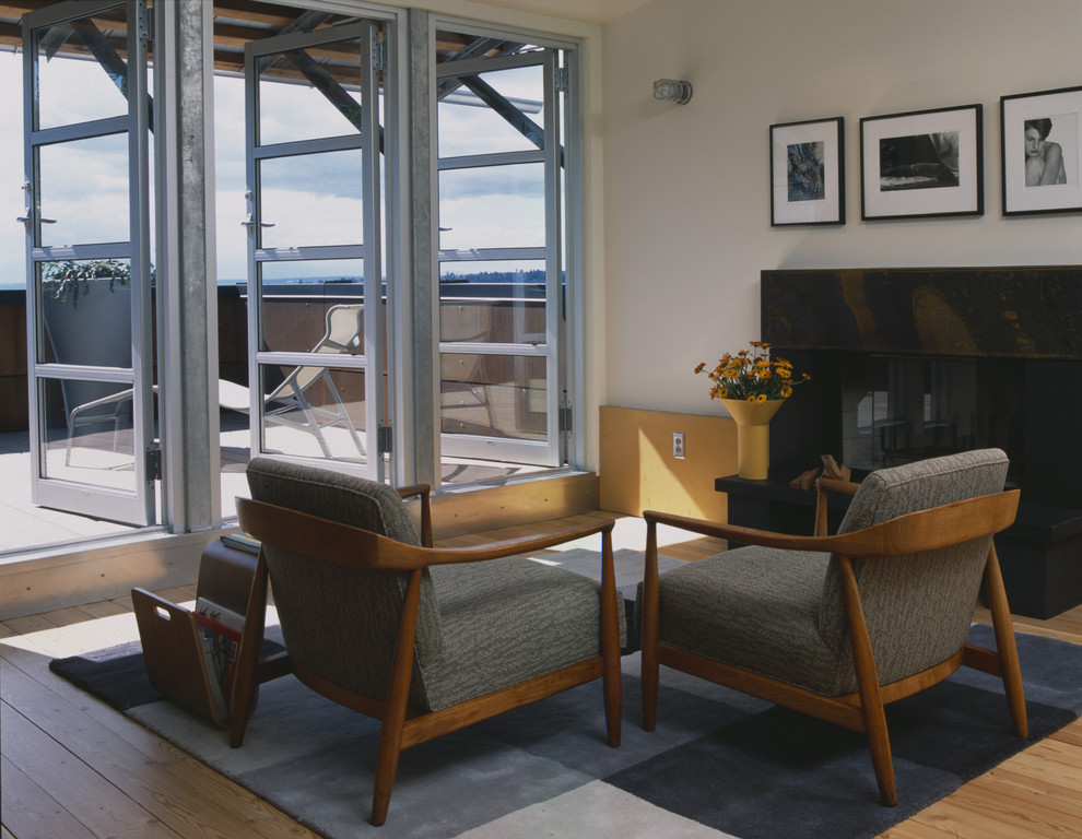 Living room - industrial living room idea in Seattle with white walls and a standard fireplace