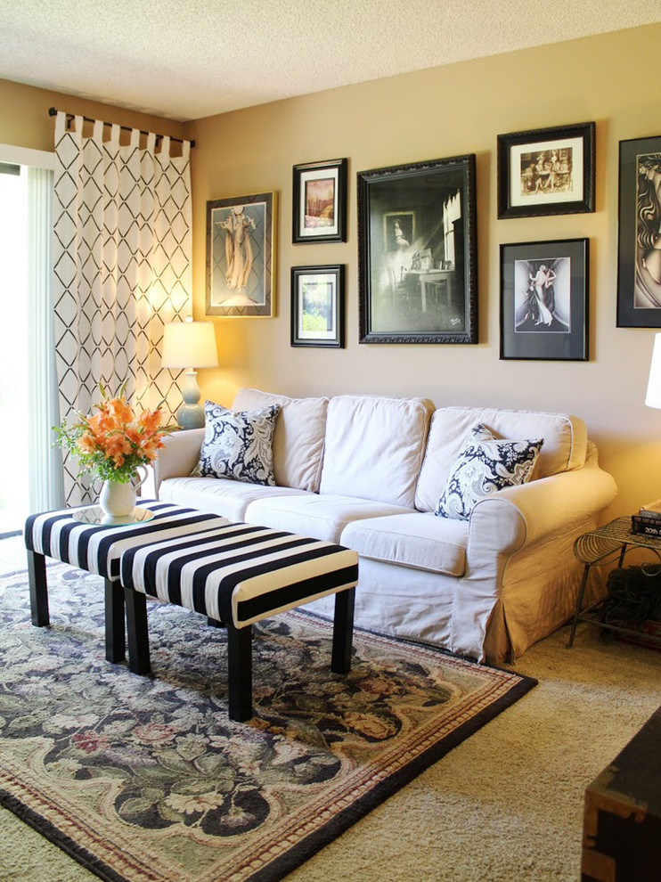 Example of a classic carpeted living room design in New York with a wall-mounted tv