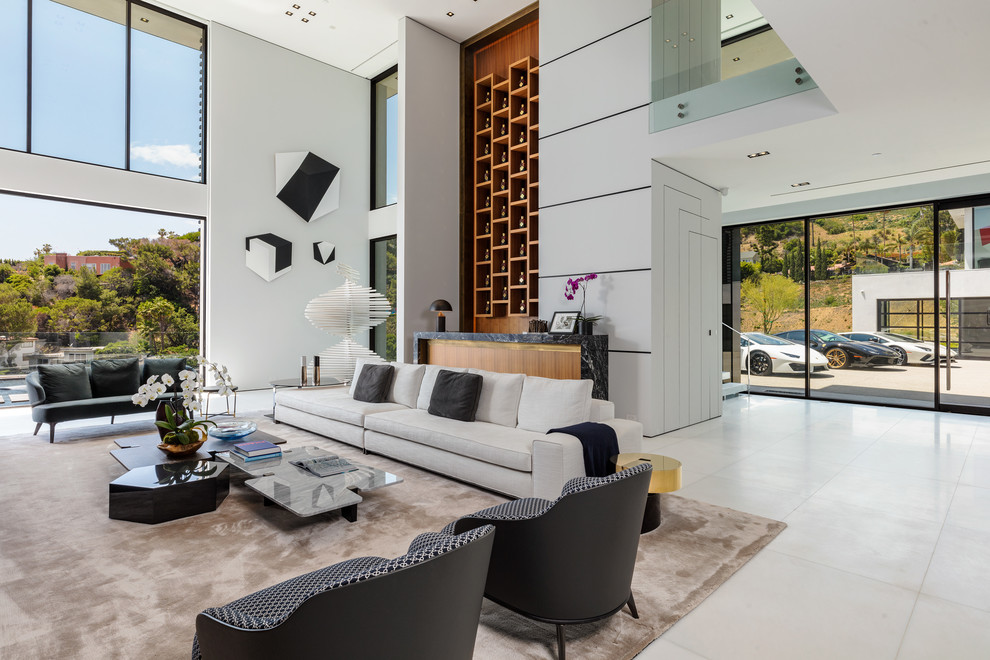 Contemporary open plan living room in Los Angeles with white walls and white floors.