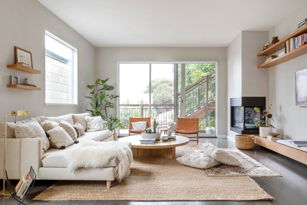 Living room - large scandinavian open concept dark wood floor and brown floor living room idea in New York with gray walls, a corner fireplace, a metal fireplace and no tv