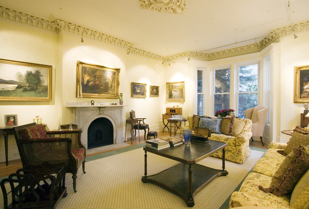 Inspiration for an expansive traditional living room in Boston with beige walls and a standard fireplace.
