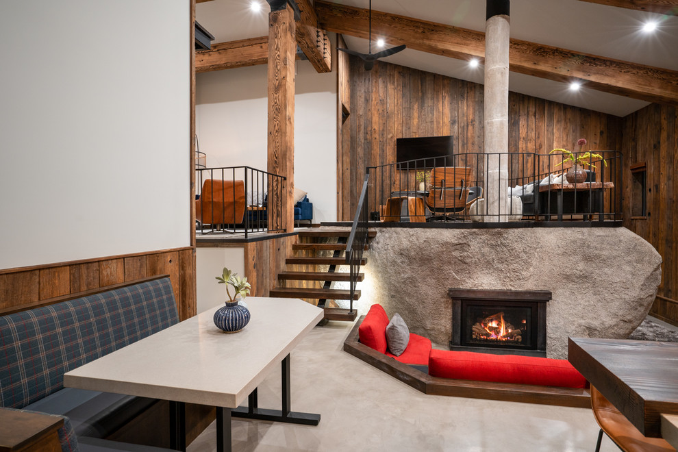 Inspiration for a rustic open concept concrete floor and gray floor living room remodel in Other with a metal fireplace
