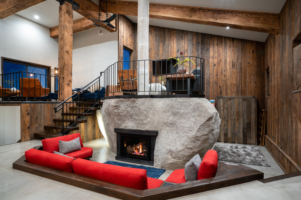 Inspiration for a rustic open concept concrete floor and gray floor living room remodel in Other with a metal fireplace