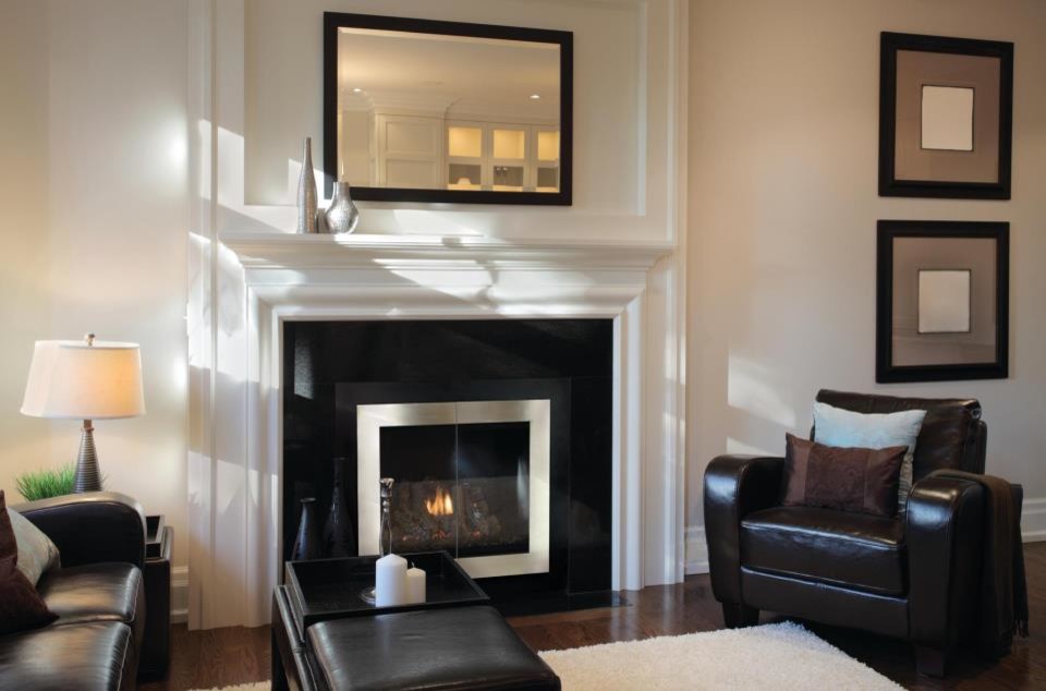 Photo of a medium sized classic formal enclosed living room in New York with a standard fireplace, a stone fireplace surround, white walls, dark hardwood flooring and no tv.