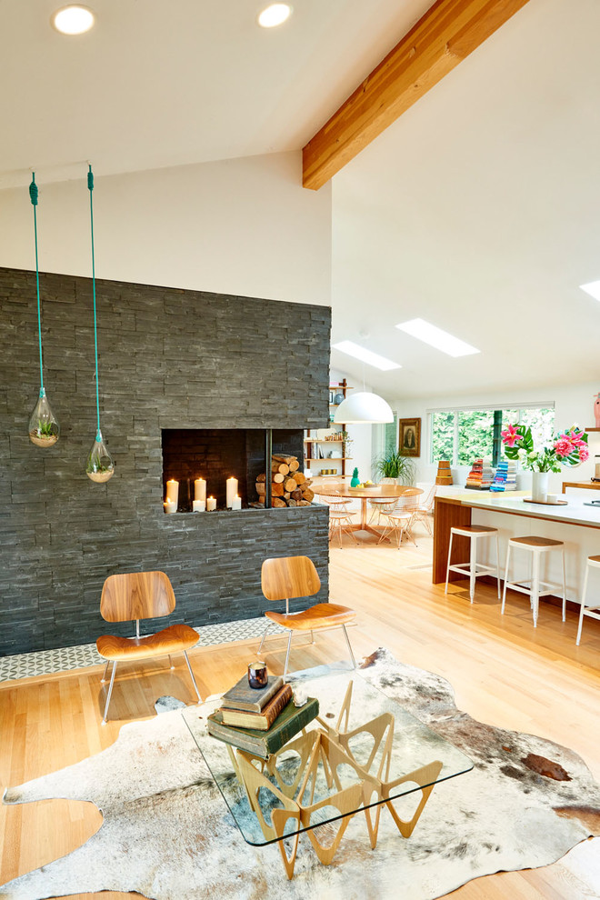 Large mid-century modern open concept light wood floor and beige floor living room photo in Portland with white walls, a standard fireplace, a stone fireplace and no tv