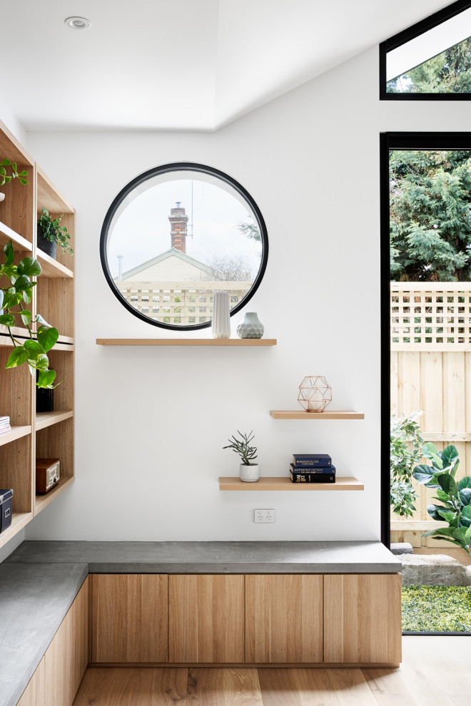 Kleines, Repräsentatives, Fernseherloses, Offenes Modernes Wohnzimmer mit weißer Wandfarbe, hellem Holzboden und braunem Boden in Melbourne