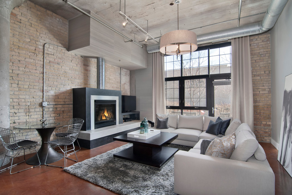 Repräsentatives, Offenes Industrial Wohnzimmer mit grauer Wandfarbe, Kamin und freistehendem TV in Minneapolis