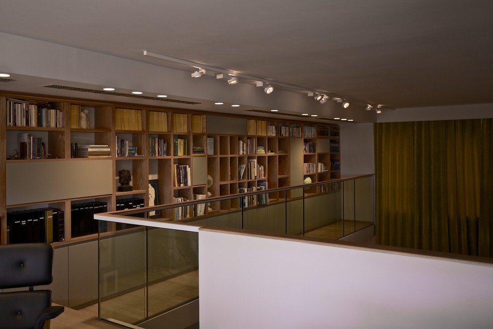 Diseño de biblioteca en casa tipo loft actual grande sin televisor con paredes grises, suelo de mármol, chimenea lineal y marco de chimenea de piedra