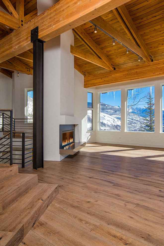 Photo of an expansive contemporary open plan living room in Denver with white walls, light hardwood flooring, a ribbon fireplace, a metal fireplace surround and no tv.