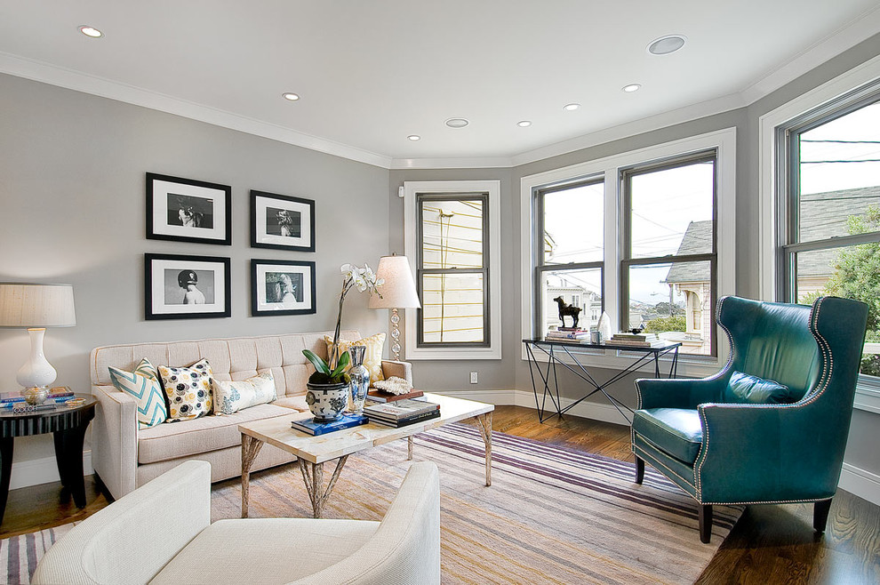 This is an example of a medium sized classic formal and grey and teal enclosed living room in San Francisco with grey walls and dark hardwood flooring.